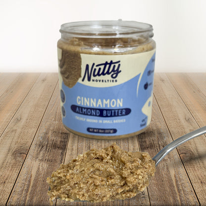 Cinnamon Almond Butter with spoon full of peanut butter in front of container